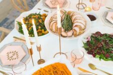 13 a lovely Thanksgiving tablescape with hexagon plates and menus, gilded candleholders, candles and pink glasses
