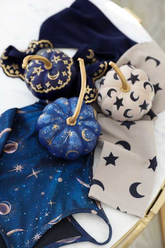 very pretty small pumpkins in blue, navy and white, with stars, moons and tiny sparkles are great for celestial Halloween parties