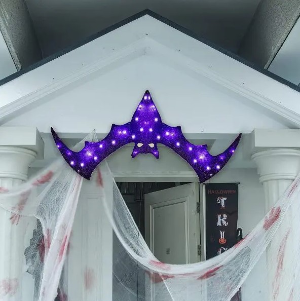 a bold and pretty purple bat marquee light over the entrace instead of a wreath or another Halloween door decoration