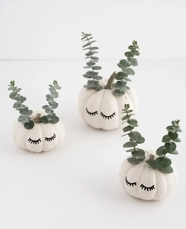 beautiful and cute white pumpkins with sharpie eyelashes and eucalyptus will be a cool and lovely idea for the fall and Halloween