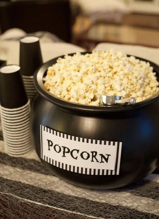 a black cauldron with popcorn is a cool way to serve this treat and it's very Halloween-inspired and cool
