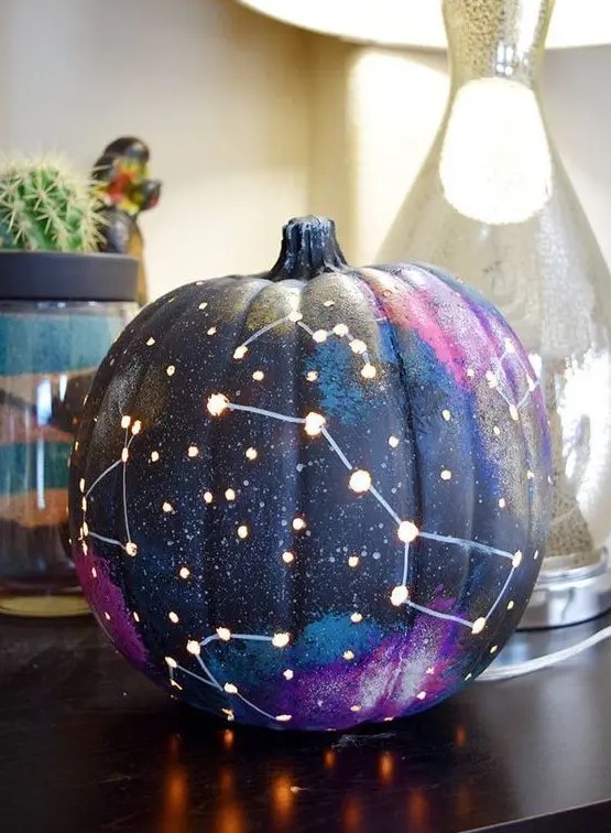a galaxy pumpkin is a trendy idea for those of your who enjoy celestial Halloween decor and want something special