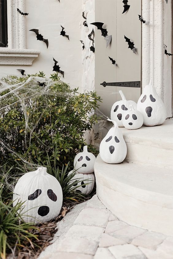 white pumpkins and gourds imitating Halloween jack-o-lanterns are an easy craft that you can make without any carving