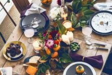 19 a modern super bold Thanksgiving tablescape with foliage, bold leaves, deep purple napkins and white and black plates