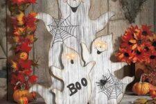 19 wood cut ghosts with webs, letters and lit up eyes for outdoor or indoor rustic decor at Halloween