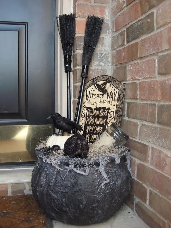 a cauldron with witch's supplies instead of flower containers at the door will be a nice solution for Halloween