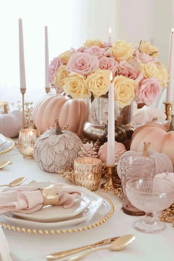 a super glam Thanksgiving table setting with blush and light pink pumpkins, copper candleholders and cutlery, tall and thin candles