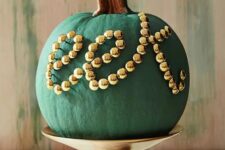 21 a chic matte green pumpkin decorated with gold beads is a chic and stylish decoration for Halloween