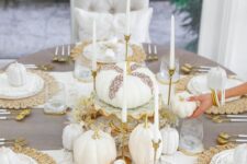22 an adorable neutral Thanksgiving tablescape with white table runners, woven placemats, white pumpkins, candles and gold touches