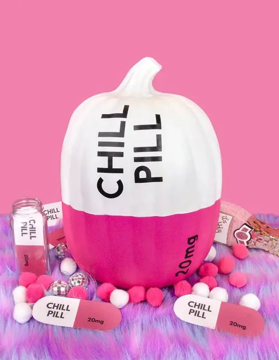 a modern color block pumpkin in hot pink and white, with black letters and numbers is a great idea for a modern Halloween party