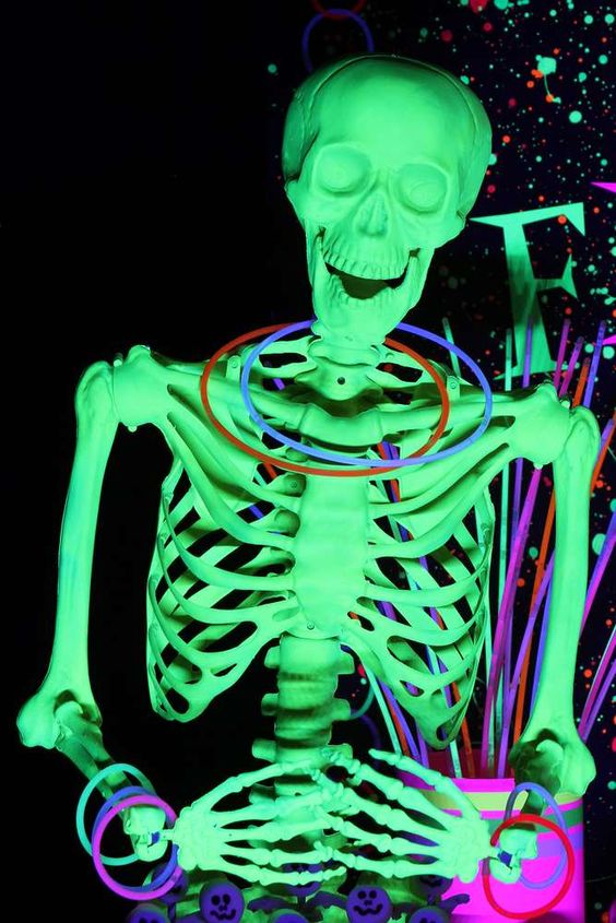 a neon green skeleton with bold neon bangles is a fun and cool idea for a neon Halloween party