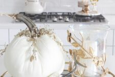 25 an elegant tray with white fabric pumpkins topped with rhinestones and pearls, a pillar candle in a candleholder