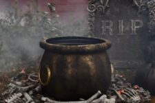 26 a realistic and scary witches’ cauldron placed on bones is a lovely outdoor decoration for Halloween