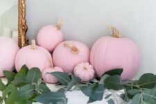 27 beautiful Thanksgiving mantel decor with matte pink pumpkins and lush greenery is a lovely idea to rock in your space