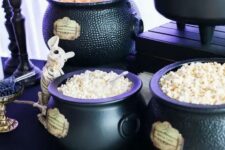 27 cauldrons used for displaying sweets at a Halloween party, they can be rocked both at a kid and adult celebration