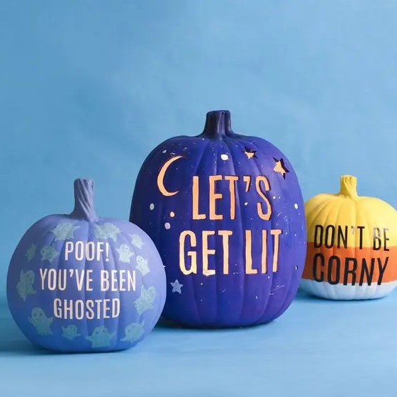 modern colorful Hallowene pumpkins in lilac, purple and orange, with drilled letters, stenciled ones and some letters