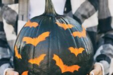 28 a black pumpkin stenciled with bats is a great idea for a modern rustic party or for your porch and it’s easy to make