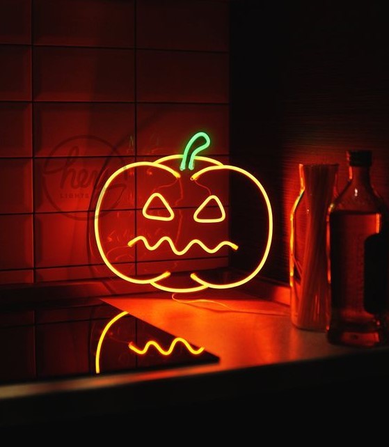 a spooky pumpkin neon sign is a great idea for Halloween, it looks bold and super cool