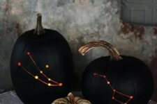 28 stylish black drilled pumpkins with lights inside instead of usual spooky carved ones are a very sophisticated Halloween decoration