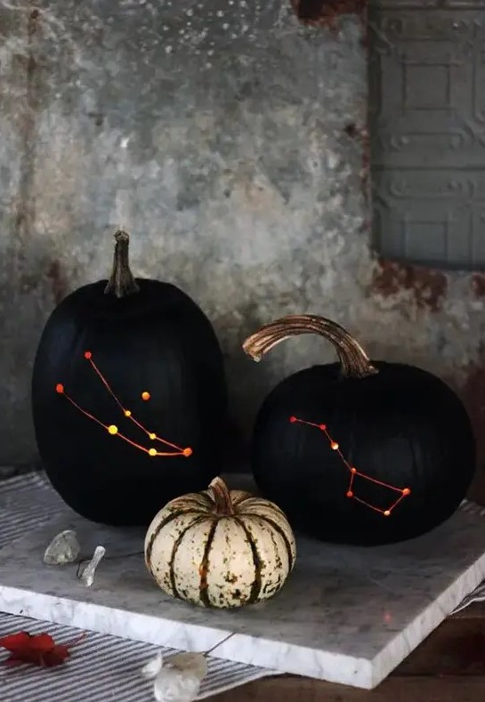 stylish black drilled pumpkins with lights inside instead of usual spooky carved ones are a very sophisticated Halloween decoration
