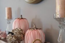29 glam fall or Thanksgiving decor with gold sequin and pink pumpkins and blush and gold candles in clear candleholders