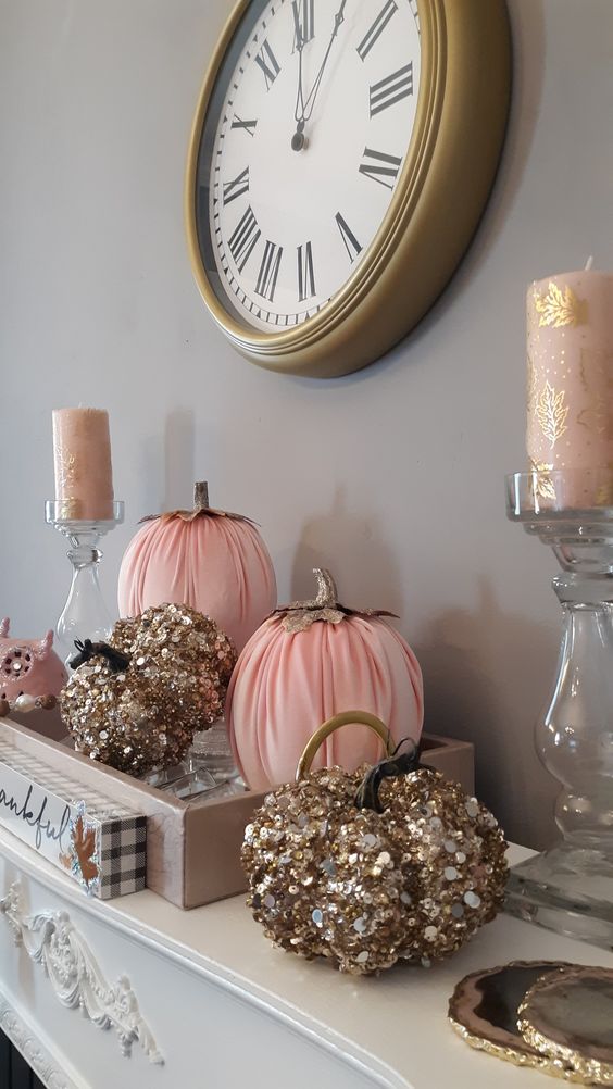 glam fall or Thanksgiving decor with gold sequin and pink pumpkins and blush and gold candles in clear candleholders