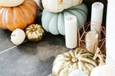 30 a fall or Thanksgiving fireplace with stacked heirloom pumkins and pilalr candles in lanterns and without them