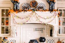 30 fun and bold Halloween decor in black and orange, with black catds, cauldrons, pumpkins, garlands and bold foliage is wow