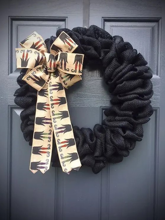 a black burlap wreath with witches' legs ribbon is a super creative idea that can be easily and fast realized for Halloween