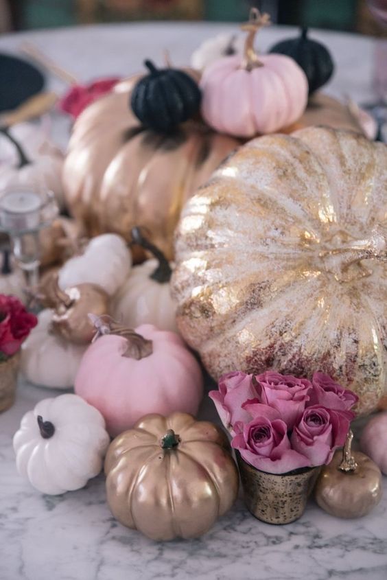 glam Thanksgiving decor with white, pink, black and gold pumpkins and pink blooms is adorable