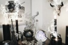 32 a chic witch’s nook with a cauldron with smoke, candles, crystals, a sphere and some signs is a gorgeous idea for Halloween