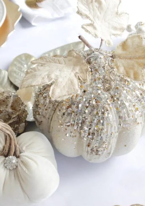 glam Thanksgiving pumpkins decorated with pearls and sequins, with gilded leaves and brooches is a lovely idea for fall, too