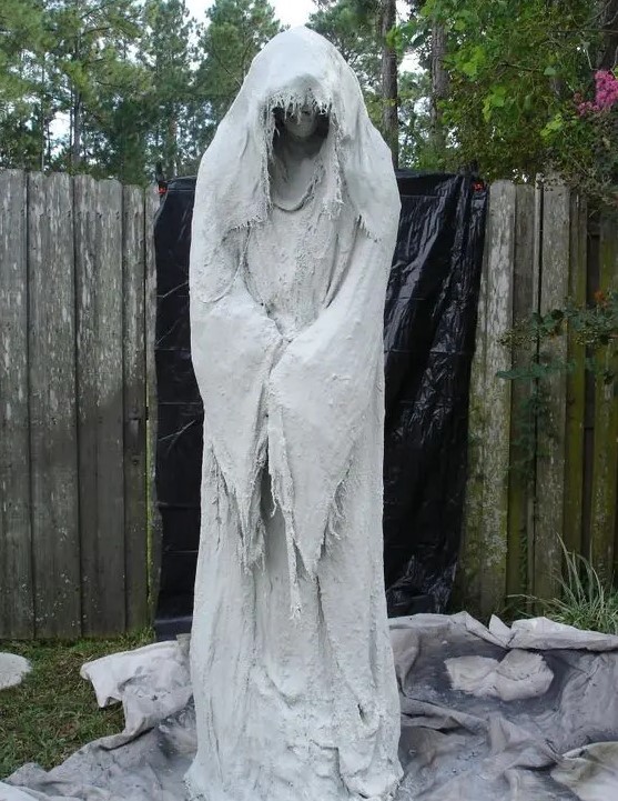 such a spooky ghost decoration can be made of cheesecloth and concrete, it's amazing for outdoors