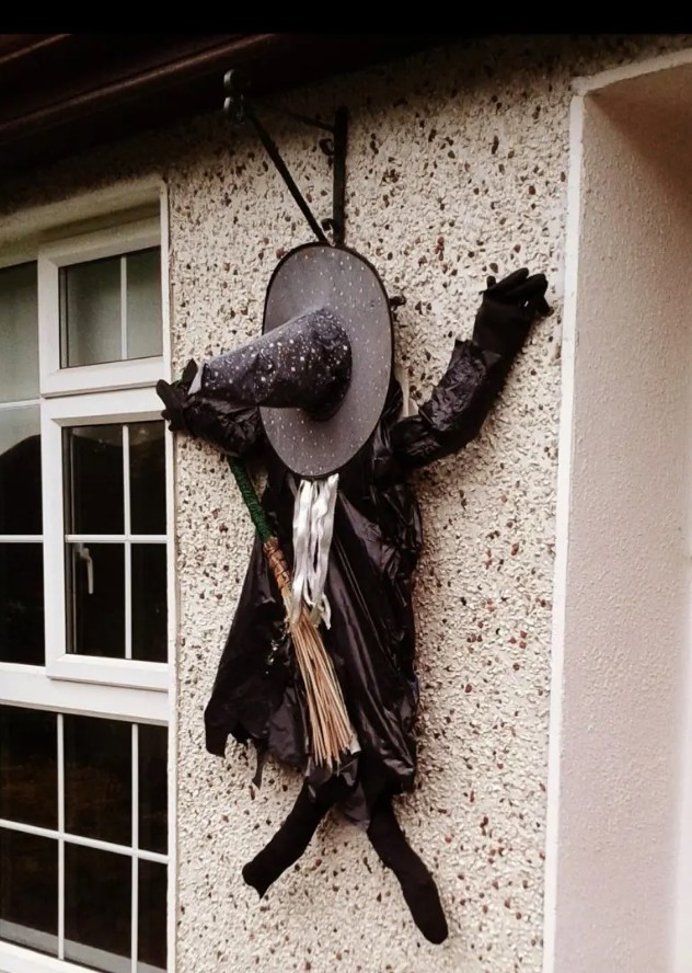 fun smashed witch decoration is a great idea for outdoor or a front door as if she was hurrying to your party