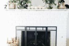 35 modern fall mantel decor with eucalyptus in clear vases, white pumpkins and candle lanterns is very easy to recreate