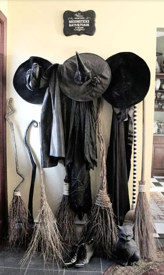 witches' gowns, hats and broomscan be placed in your entryway to make it Halloween-ready and super cool