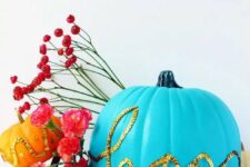 38 a bold blue pumpkin decorated with gold sequins that form a word is a cool and bright idea for Halloween