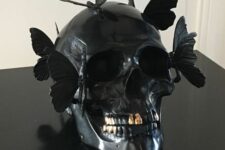 a black skull with gold teeth and black butterflies on top is a fantastic idea for Halloween
