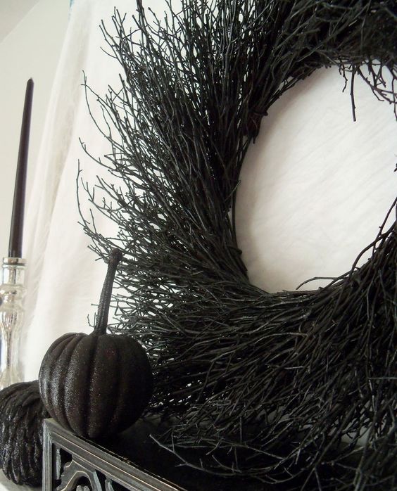 a black twig wreath paired with black shiny pumpkins are great Halloween decor in a classic color