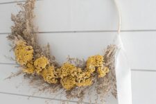 a dreamy Thanksgiving wreath of an embroidery hoop with dried grasses and blooms plus a white ribbon is all cool