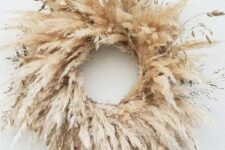 a lovely pampas grass wreath with some additional grass is a lovely and pretty solution for a fall or Thanksgiving celebration