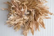 a messy corn husk and grasses wreath like this one is easy to make for cheap and it will look absolutely nice