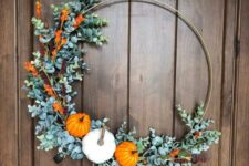 a modern embroidery hoop Thanksgiving wreath with faux greenery, blooms and mini pumpkins is a cool modern solution
