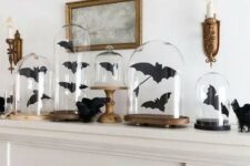 black paper bats in cloches and on the mantel are great to style it for Halloween, and they are easy to craft