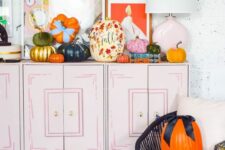 bold and beautiful fall pumpkins with painted blooms and leave,s in bold colors and with bows are amazing