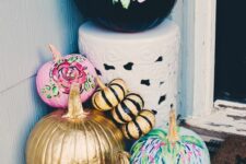 bright fall pumpkins – black with pink florals, pink, green, leopard, gold and blakc stripe ones – for fall porch decor