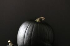 matte black pumpkins with metallic stems are a stylish modern Halloween decor idea to rock