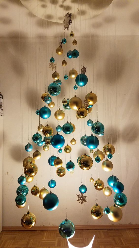 a beautiful floating Christmas tree of turquoise and gold ornaments of various sizes and shapes is amazing