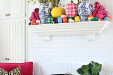 02 a bold and bright fall mantel with colorful pumpkins, plaid and color block ones plus yellow blooms in vases is amazing