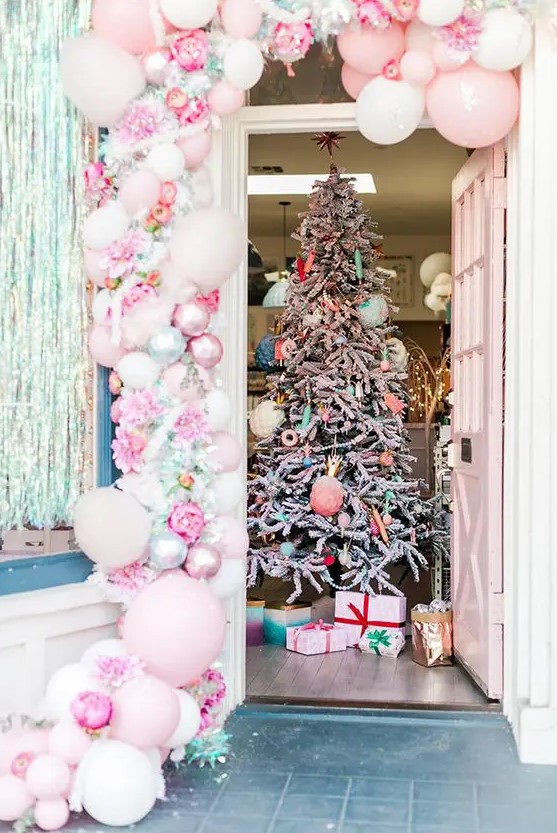 a fantastic pink balloon, pink peony, shiny garland and a Christmas tree with pastel ornaments and beads are amazing for a candy-inspired Christmas celebration